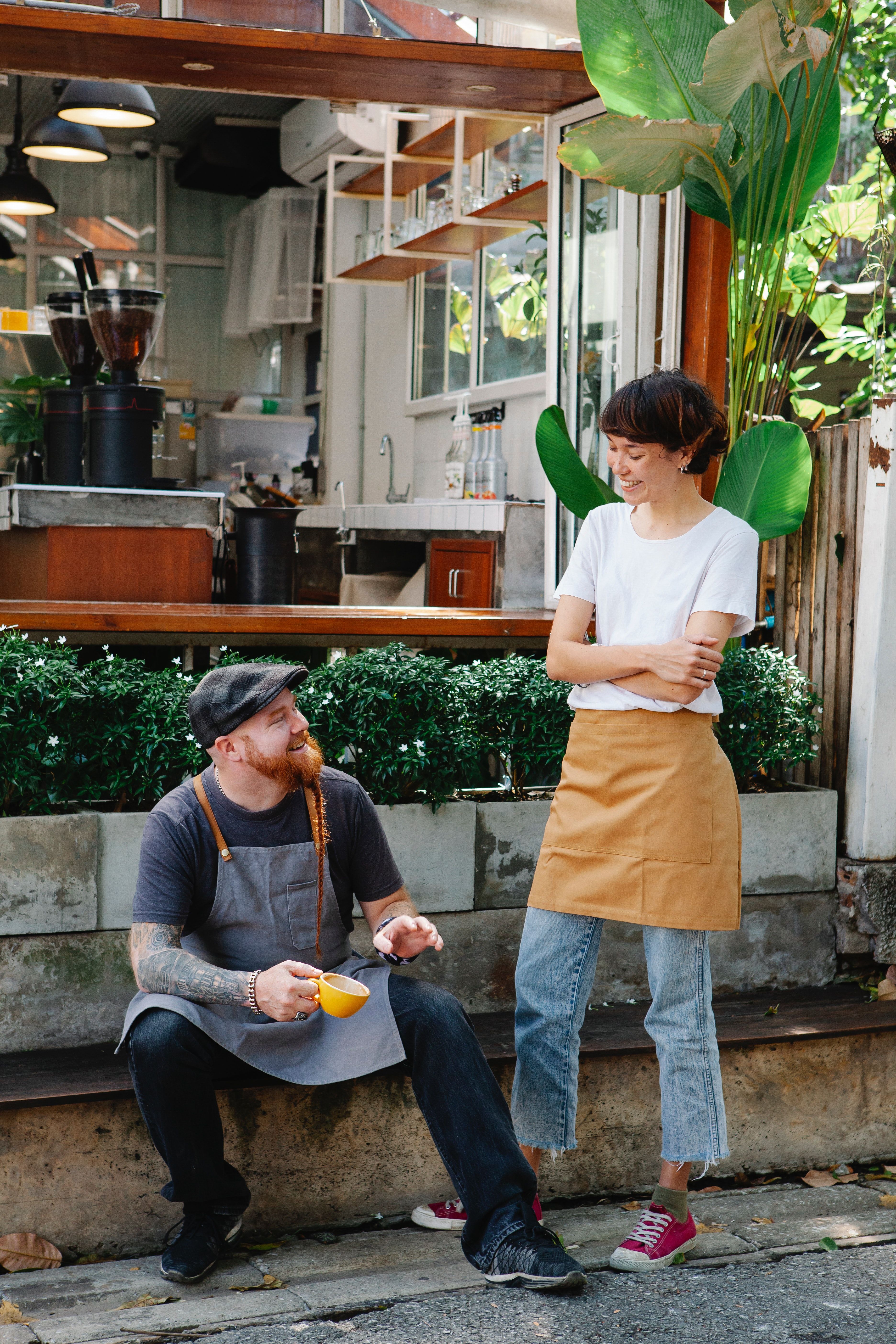 The couple who own the coffee shop, hanging out outside the shop chatting away.